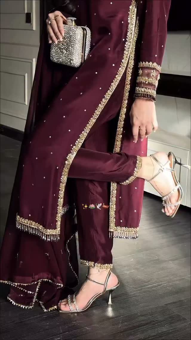 Maroon embroidered ethnic formal attire with silver heels and a sparkling clutch bag.