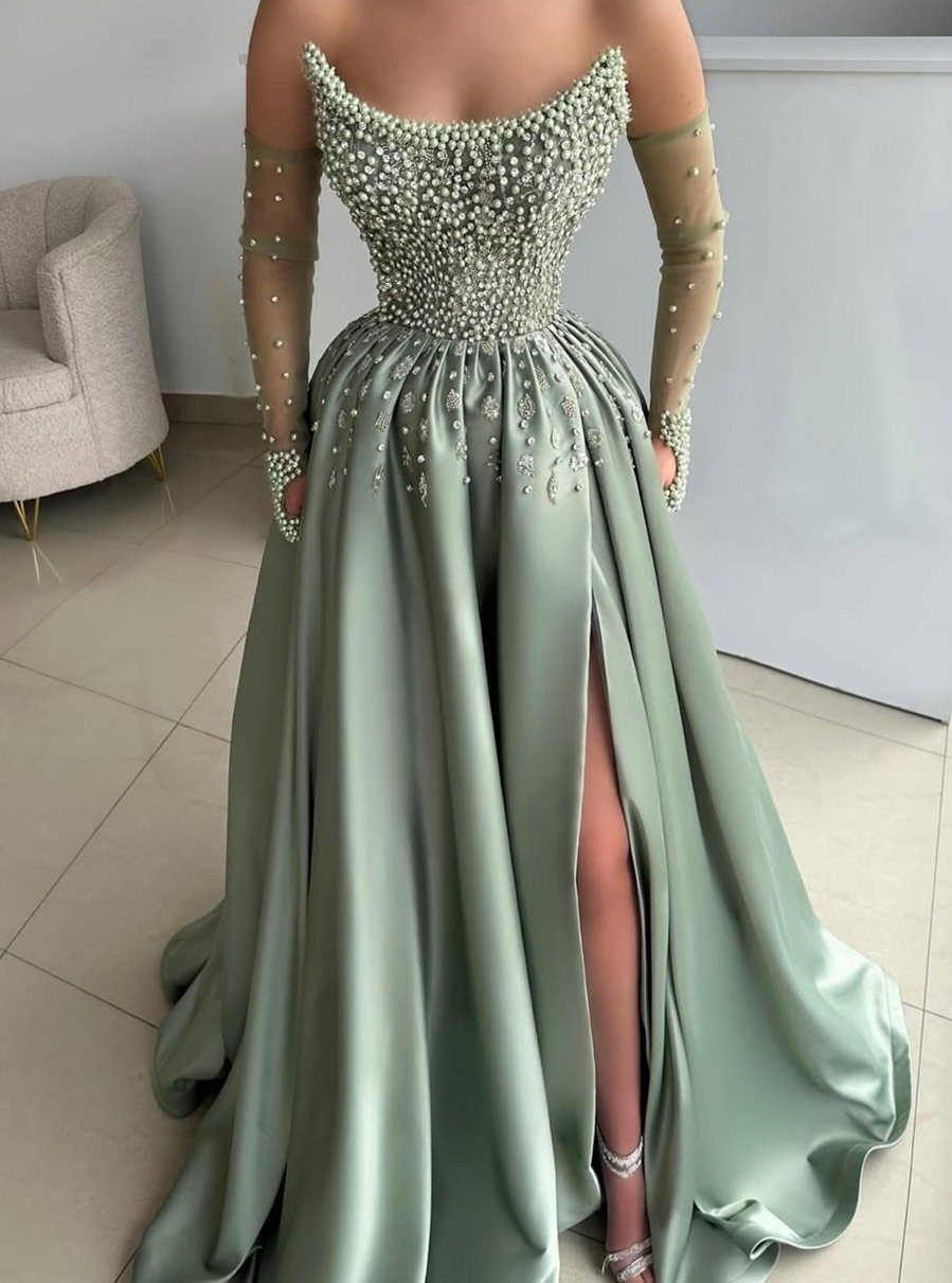 Sage green beaded gown with a voluminous satin skirt and high slit worn by a person.