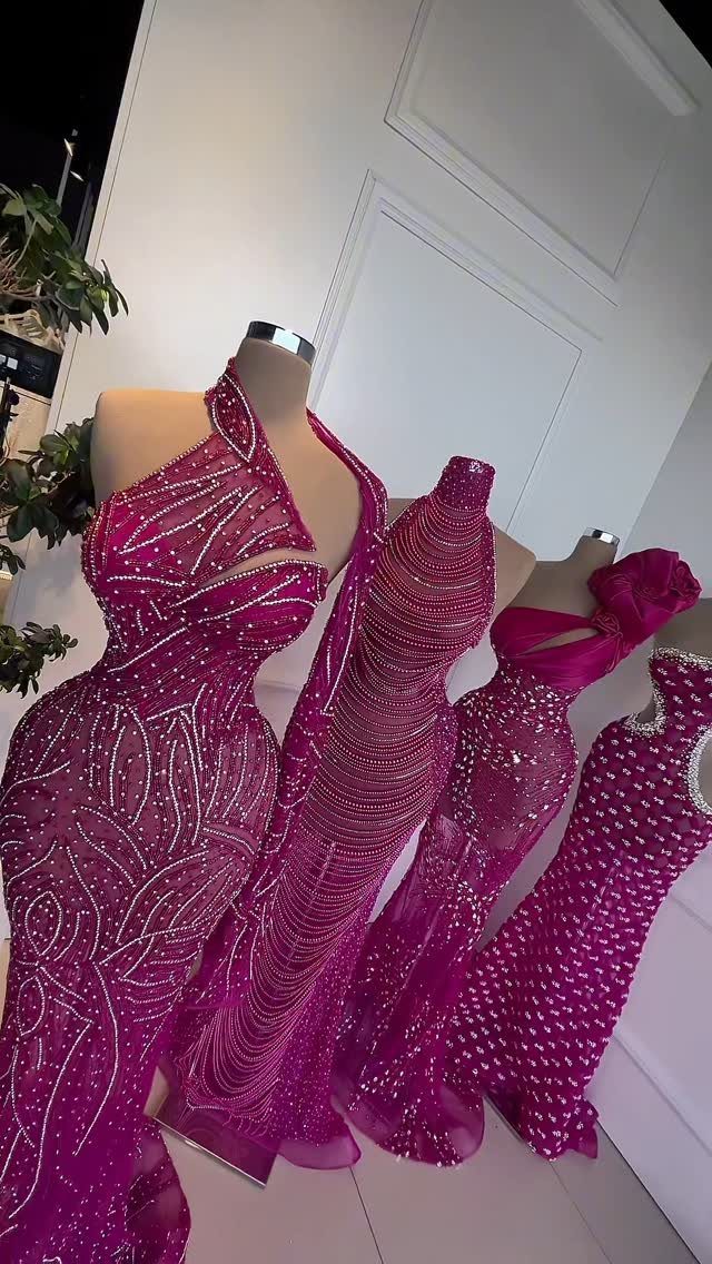Three magenta beaded formal dresses displayed on mannequins against a white door.