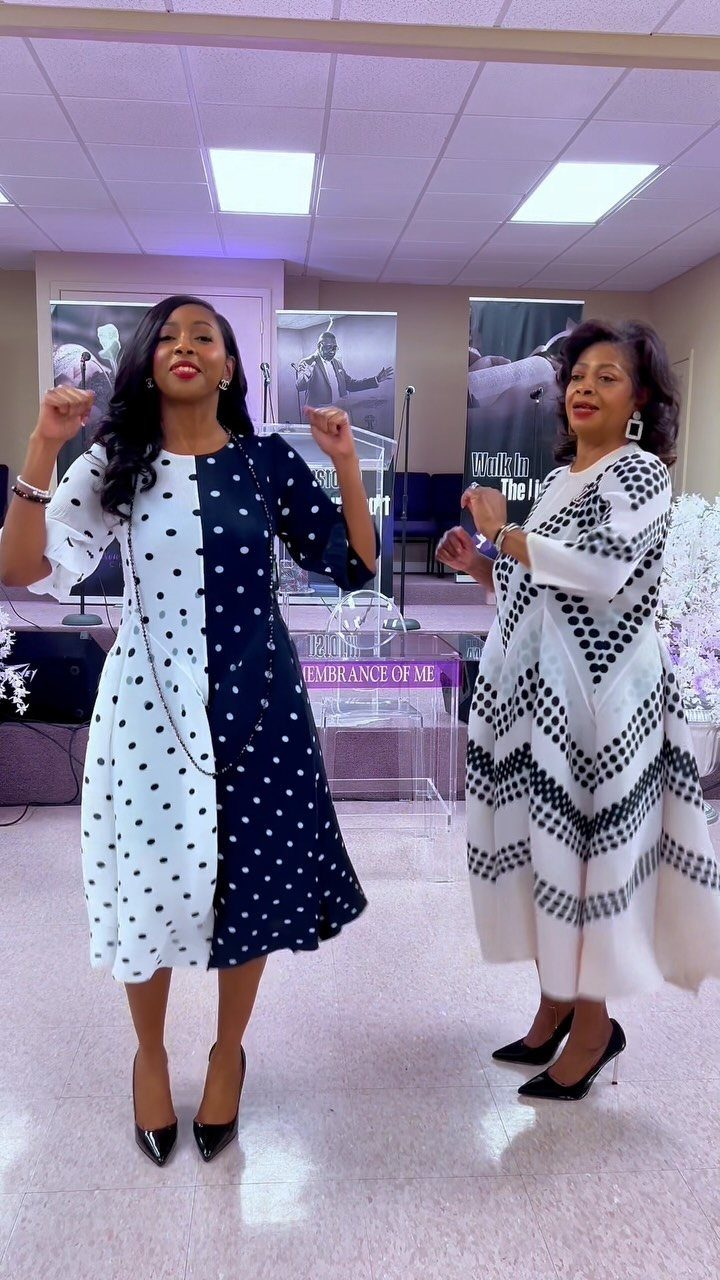 Two women posing in patterned dresses, one in polka dots and one in black and white chevrons.