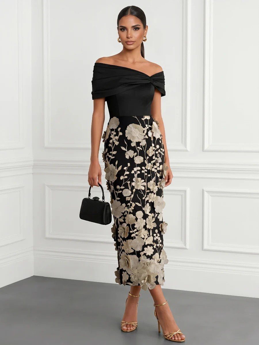 A woman wearing a black floral appliqué skirt and off-the-shoulder top with gold sandals.