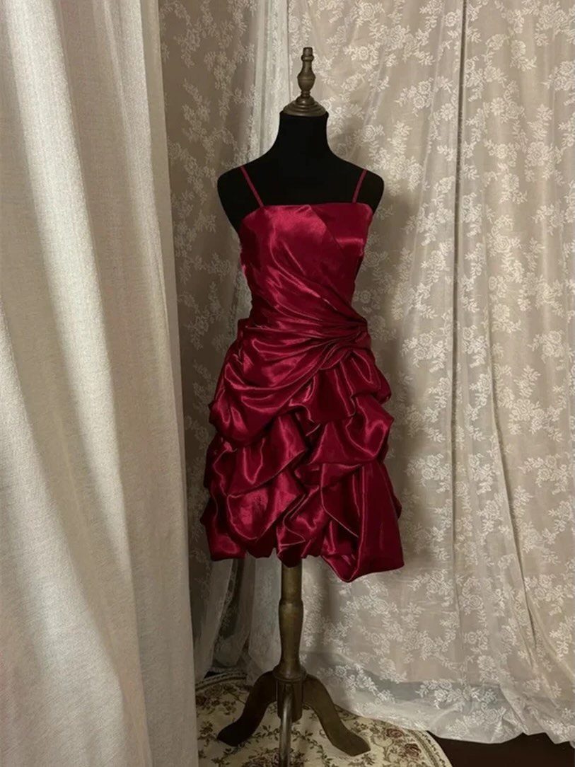 Burgundy satin mini dress with ruffled skirt displayed on a black mannequin torso.