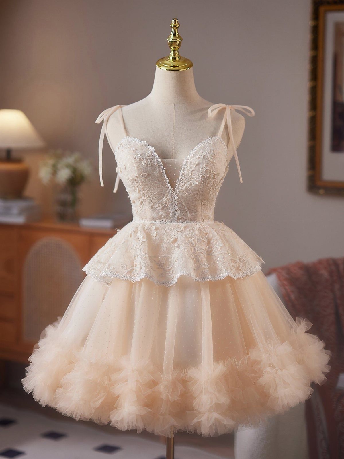 Champagne mesh mini dress with floral lace embroidery and a voluminous ruffled tulle skirt on a mannequin.