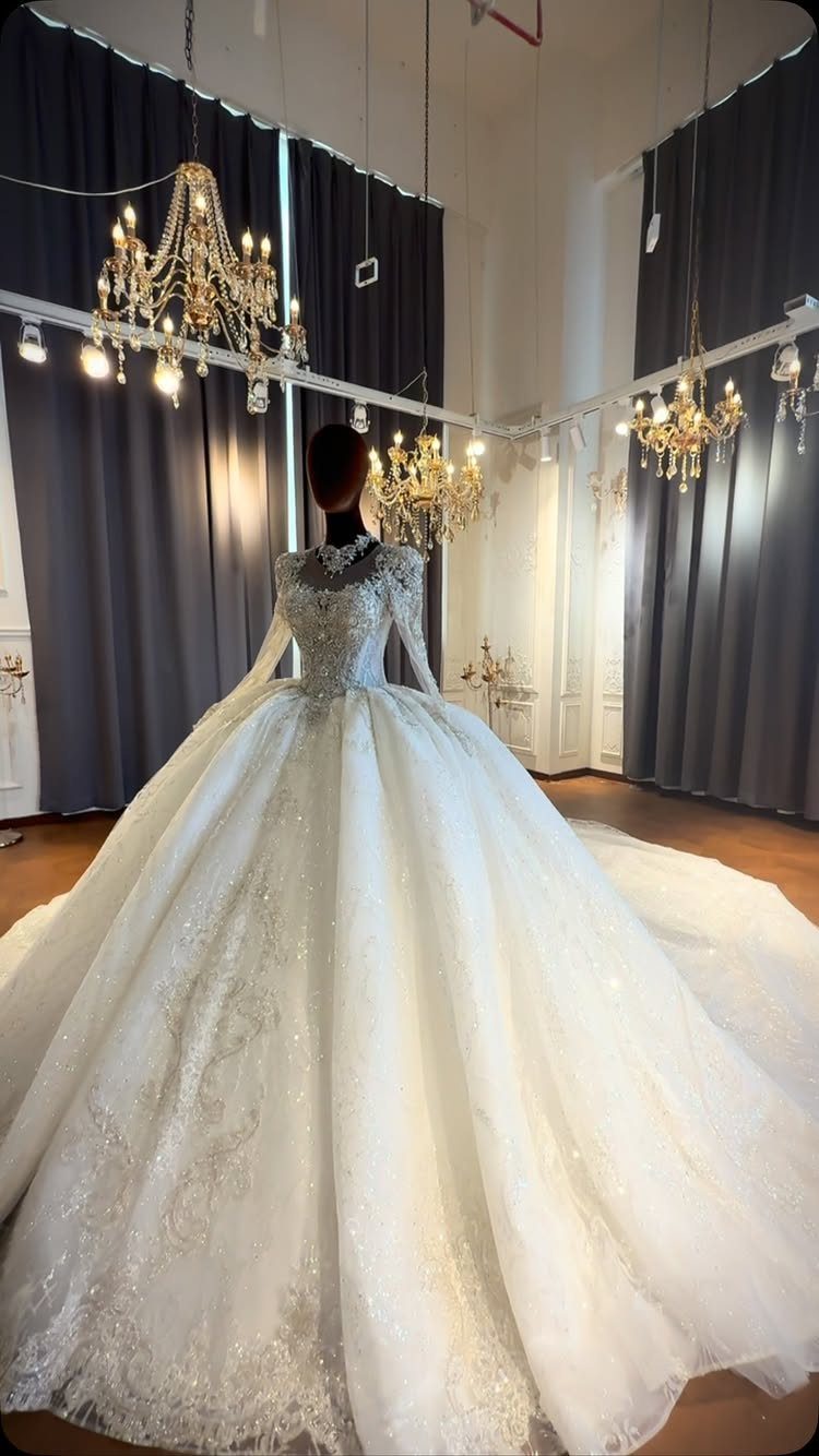 A voluminous white ball gown wedding dress with a fitted bodice displayed on a mannequin.