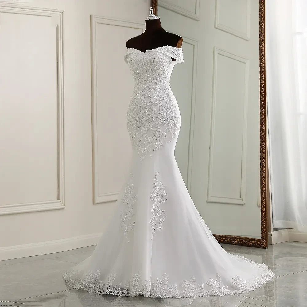 White lace mermaid wedding dress on a mannequin with an off-the-shoulder neckline.