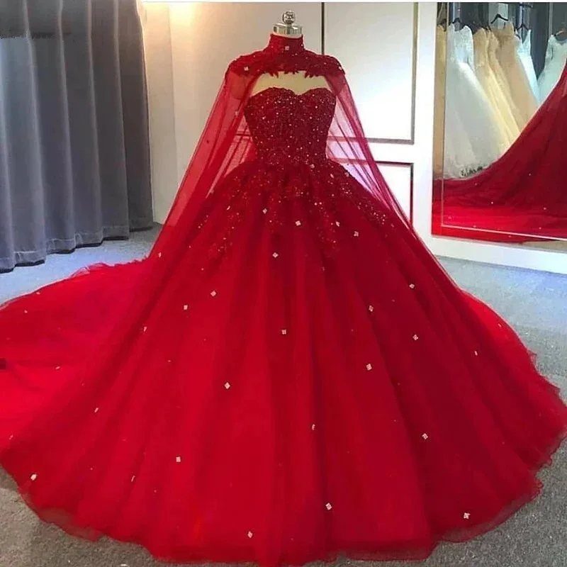 A voluminous red wedding gown with sparkling embellishments displayed on a mannequin.