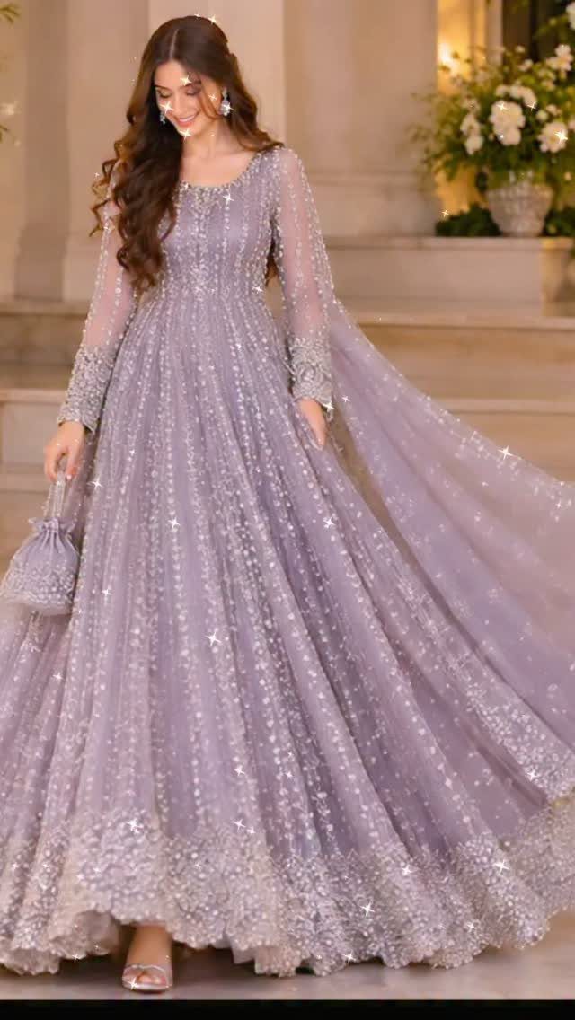 Woman in a shimmering, long-sleeved dusty lavender gown with sequin embellishments.